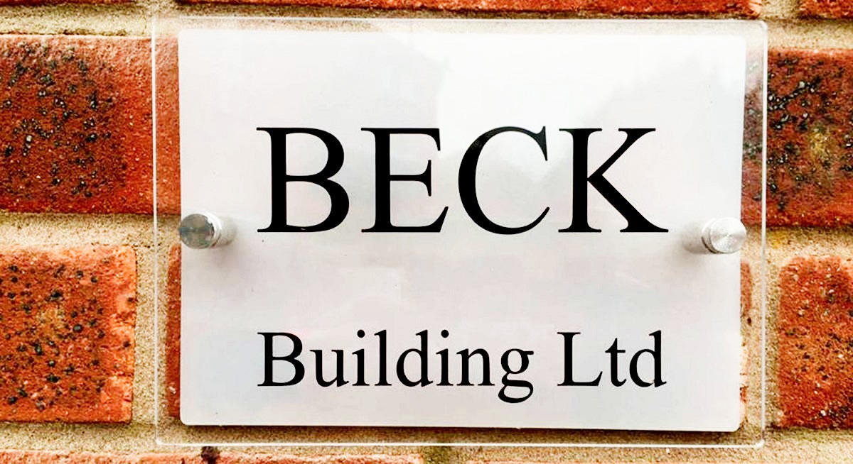 Beck Building Ltd sign mounted on brick wall
